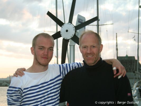 28 June /  Børge and his son Max enjoyed a few hours in Bergen, before parting ways for now. Behind them can be seen the wind generator, which provides the power needed on board.