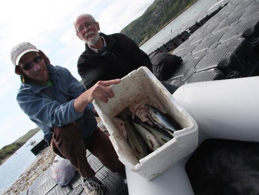 2 June.  A fisherman hands to Bertrand and Jacques the ingredients for a fresh fish soup.