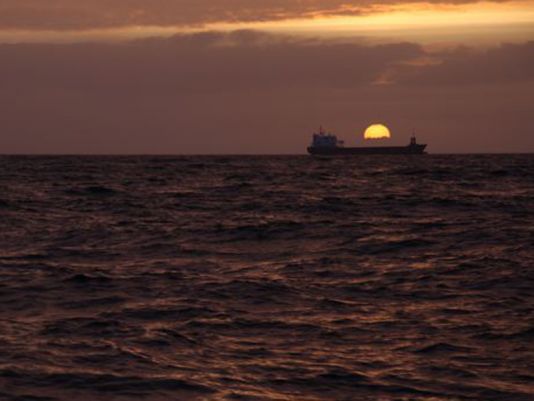 17 May 2011, first encounter with a cargo ship, at sunset. The 10 knot breeze has reappeared.