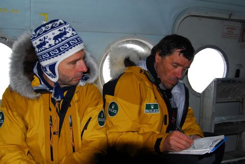 On the helicoter MI8 that will bring them to the departure point, Alain looks over his notes.