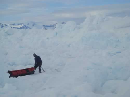 13 June: Before A Wall: Dixie is wondering how on earth he'll be able to climb this wall of ice.