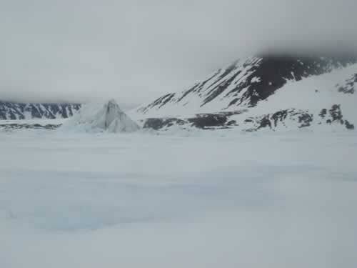 14 June: The Mountains Are Getting Nearer: The last iceberg before the coast.