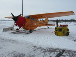 The Polar Pumpkin tied down for approaching bad weather at Inuvik Airport